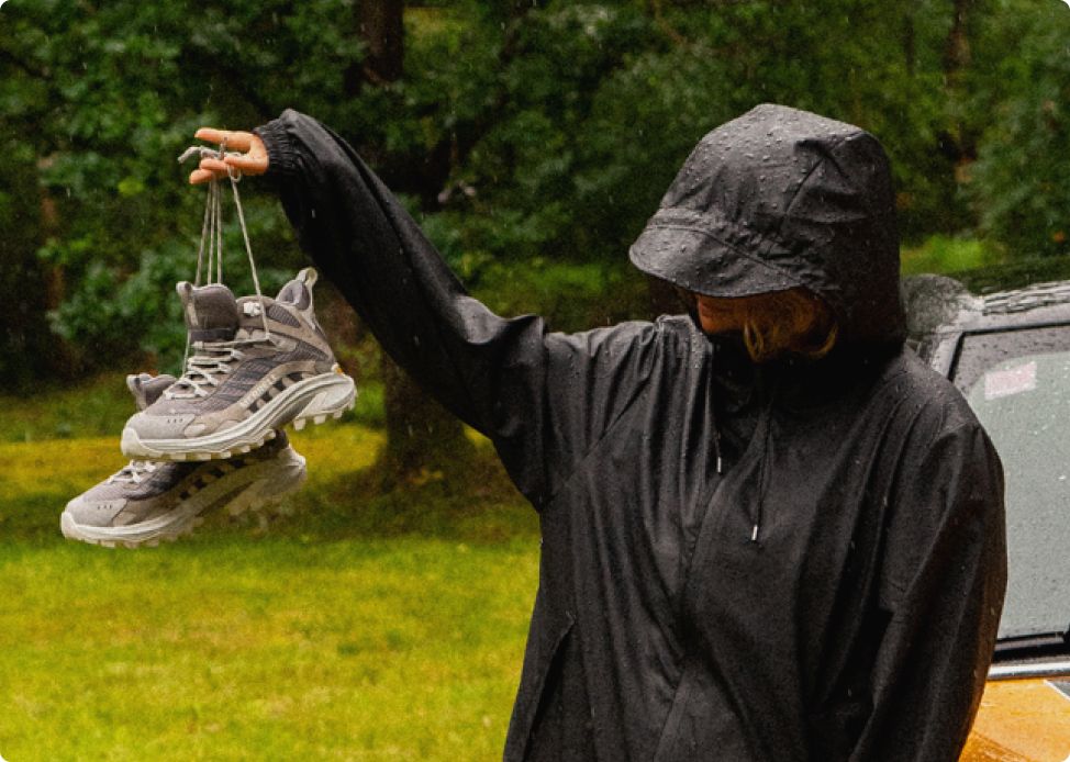 Person holding up wearing Merrell shoes